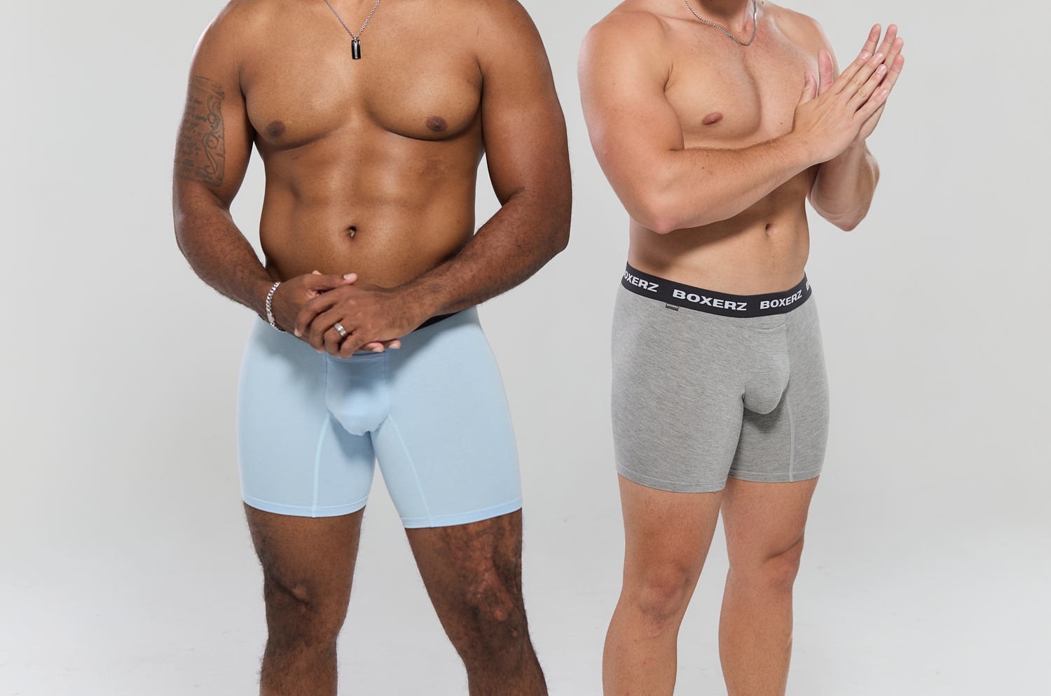 Two men side-by-side wearing white and grey Boxer Briefs