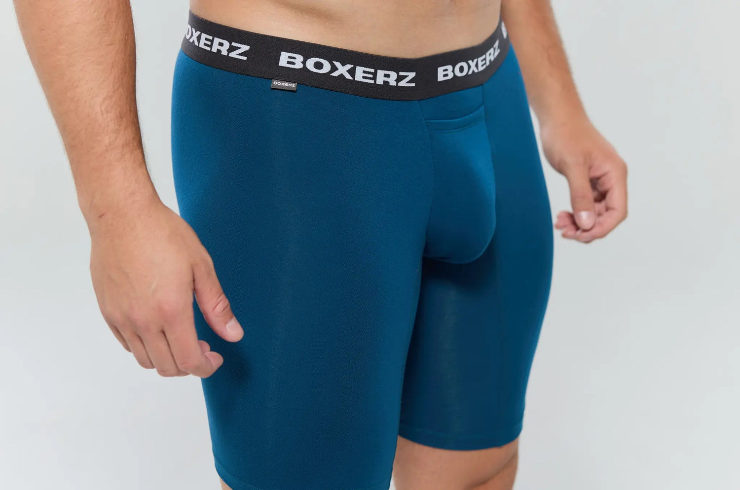 Close-up of blue Boxer Brief Sports+ showing leg length and waistband branding