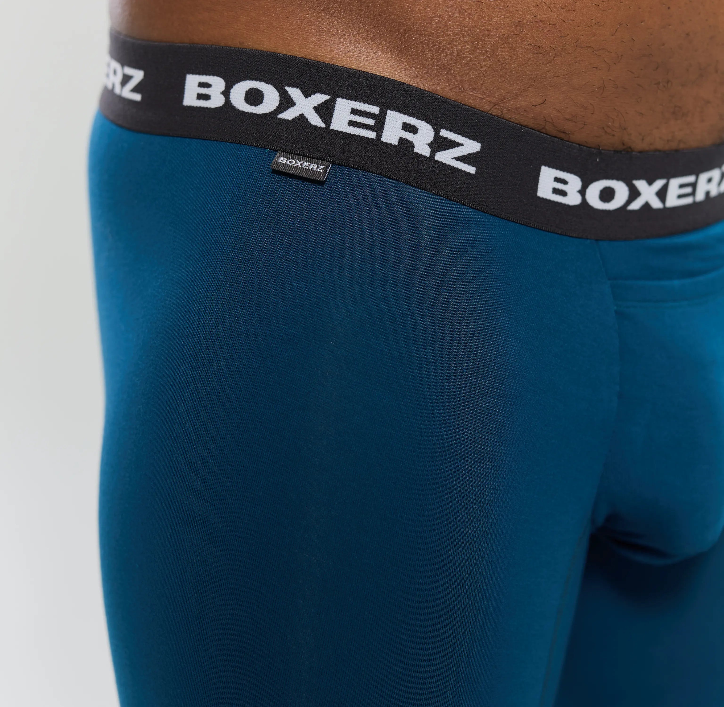 Close-up of Boxerz waistband on midnight blue boxer briefs, showing logo and stitching details
