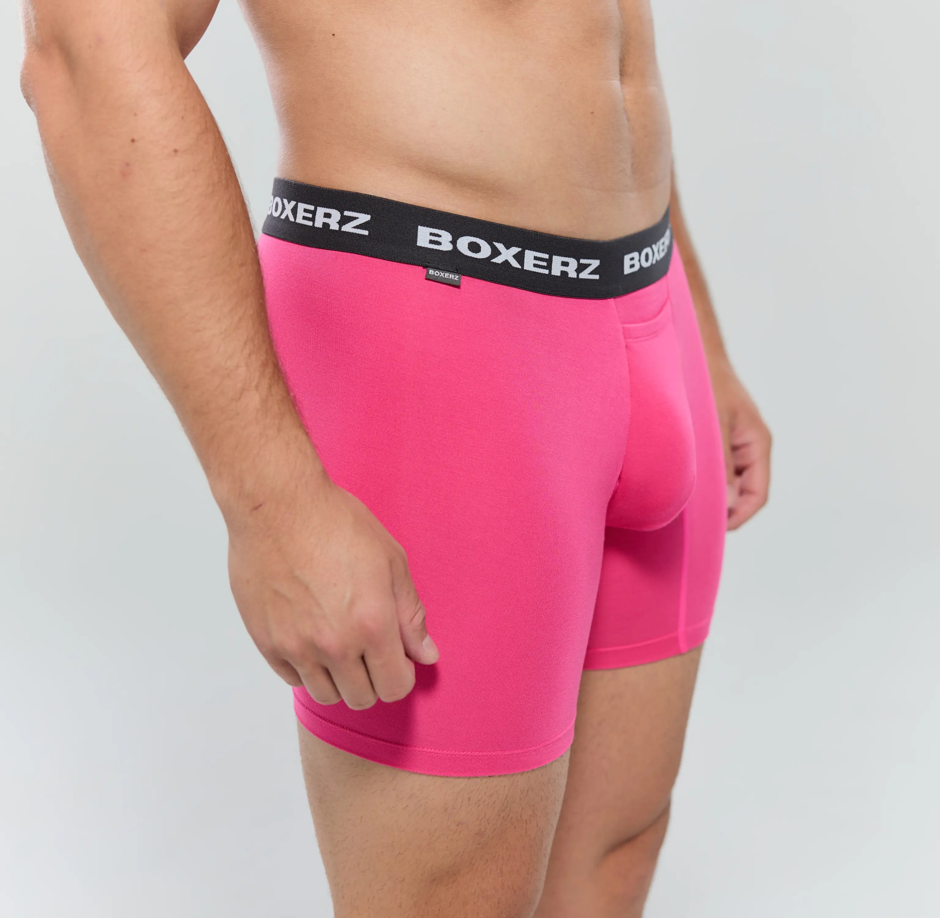 Side profile of pink boxer briefs, highlighting snug fit and stretch fabric