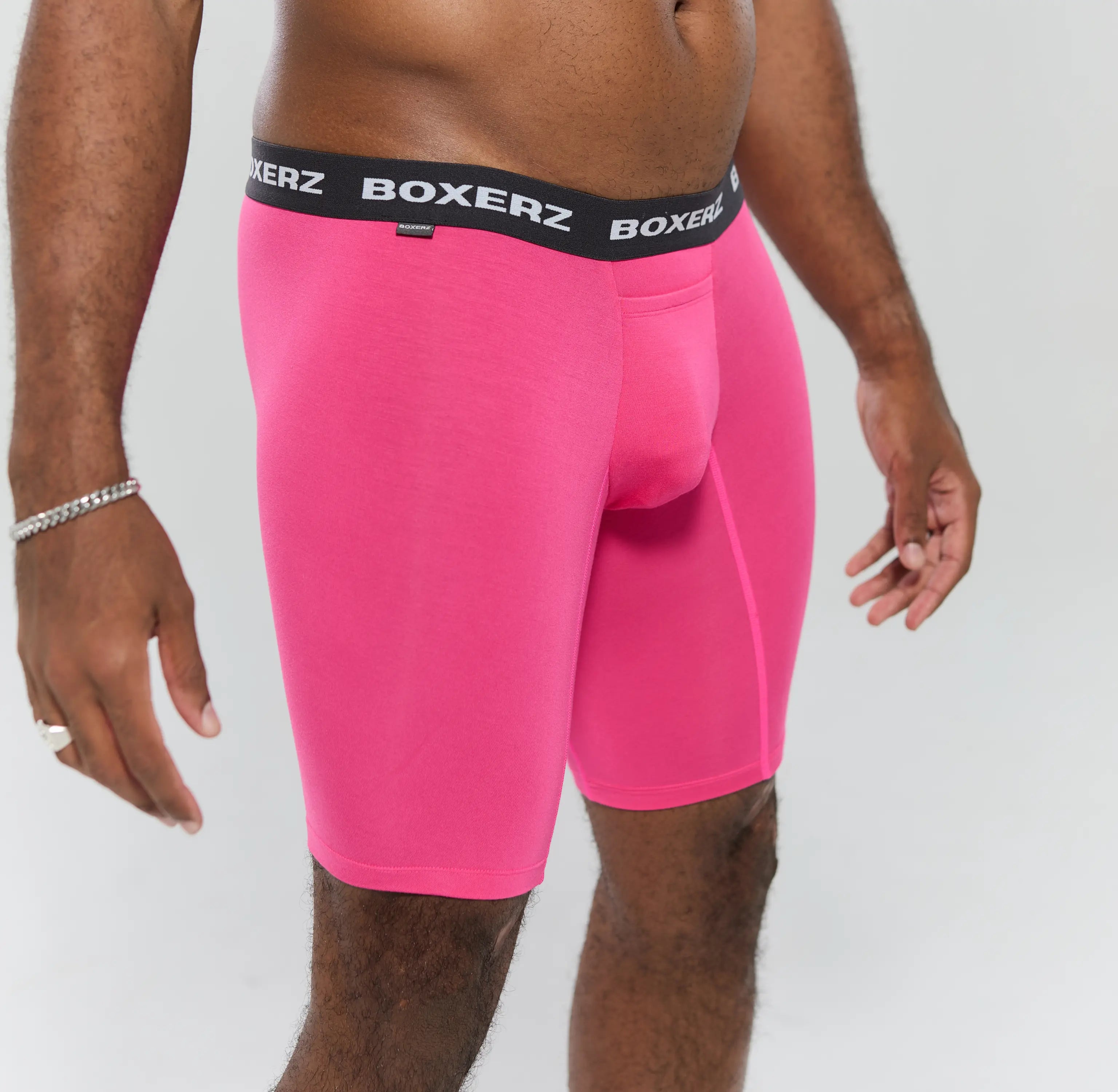 Side profile of pink boxer briefs, highlighting snug fit and stretch fabric