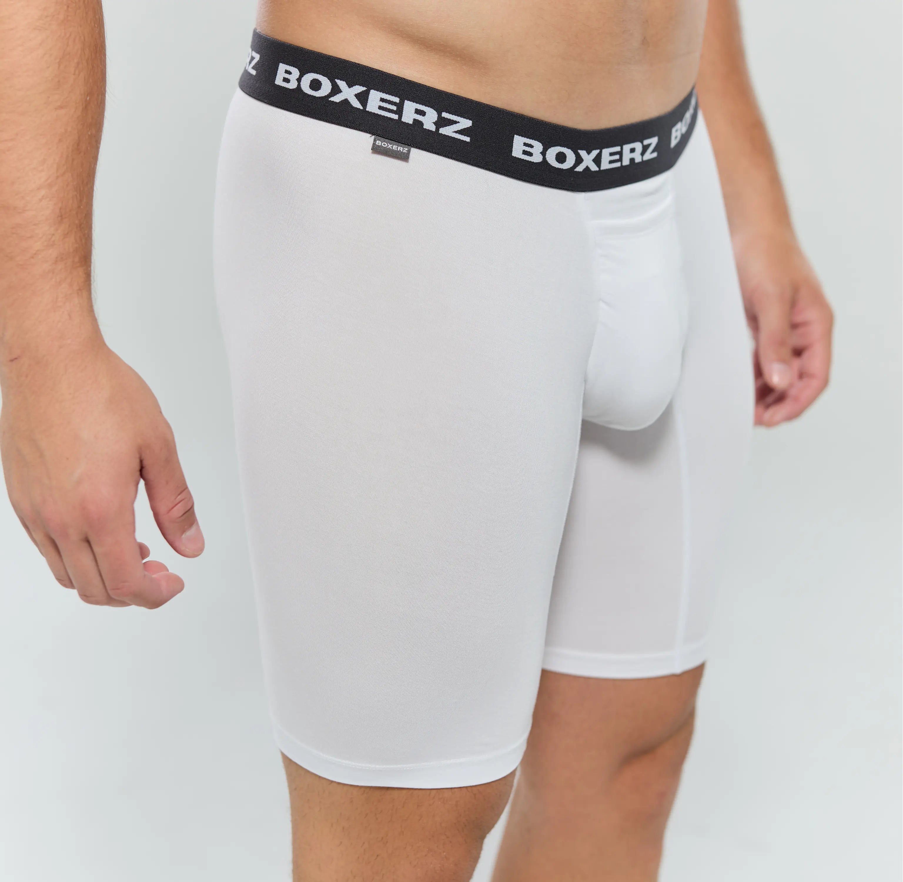 Side profile of white boxer briefs, highlighting snug fit and stretch fabric