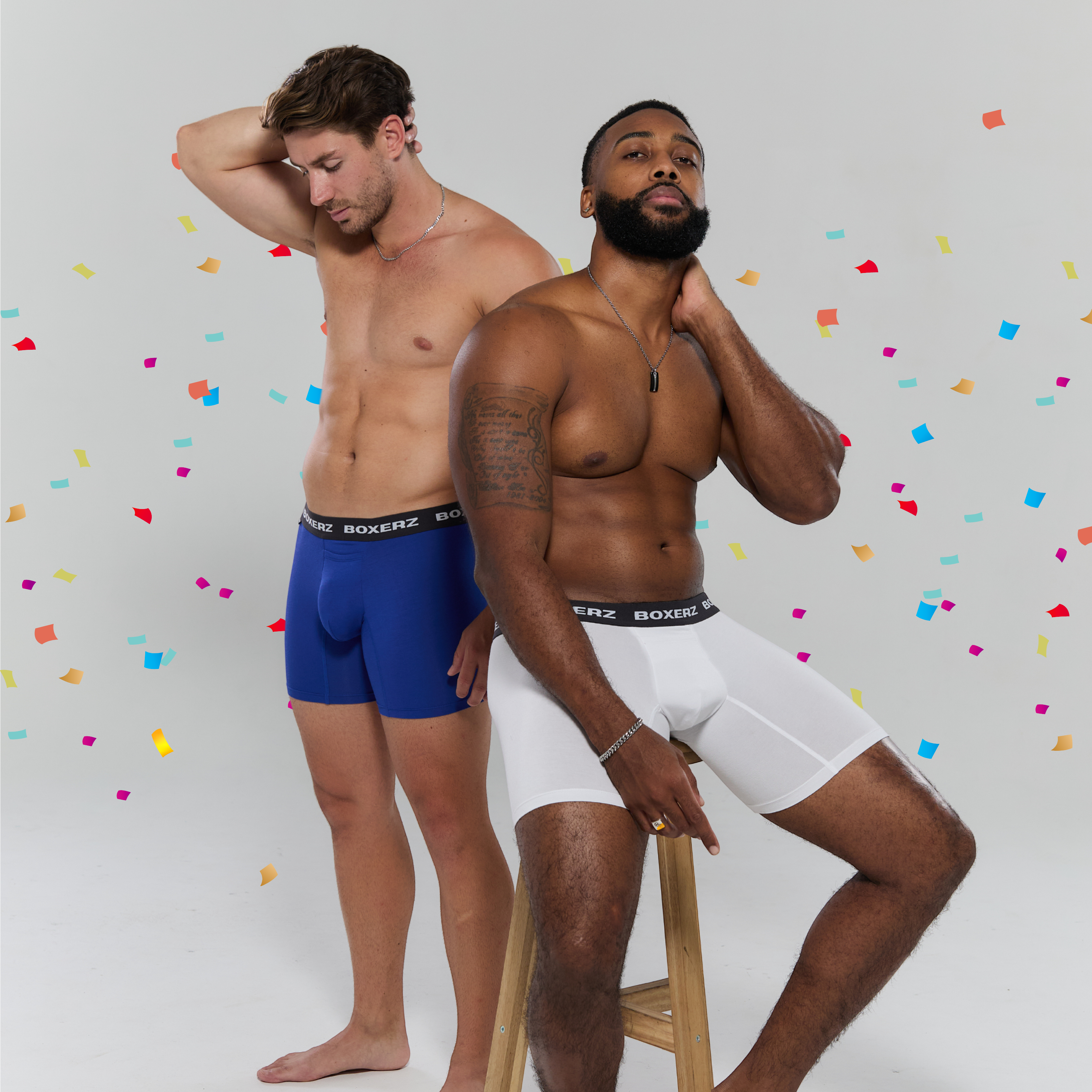 Two male models wearing Boxerz boxer briefs—one in blue, one in white—posed confidently against a light backdrop with colourful falling confetti, showcasing comfort, fit, and vibrant style