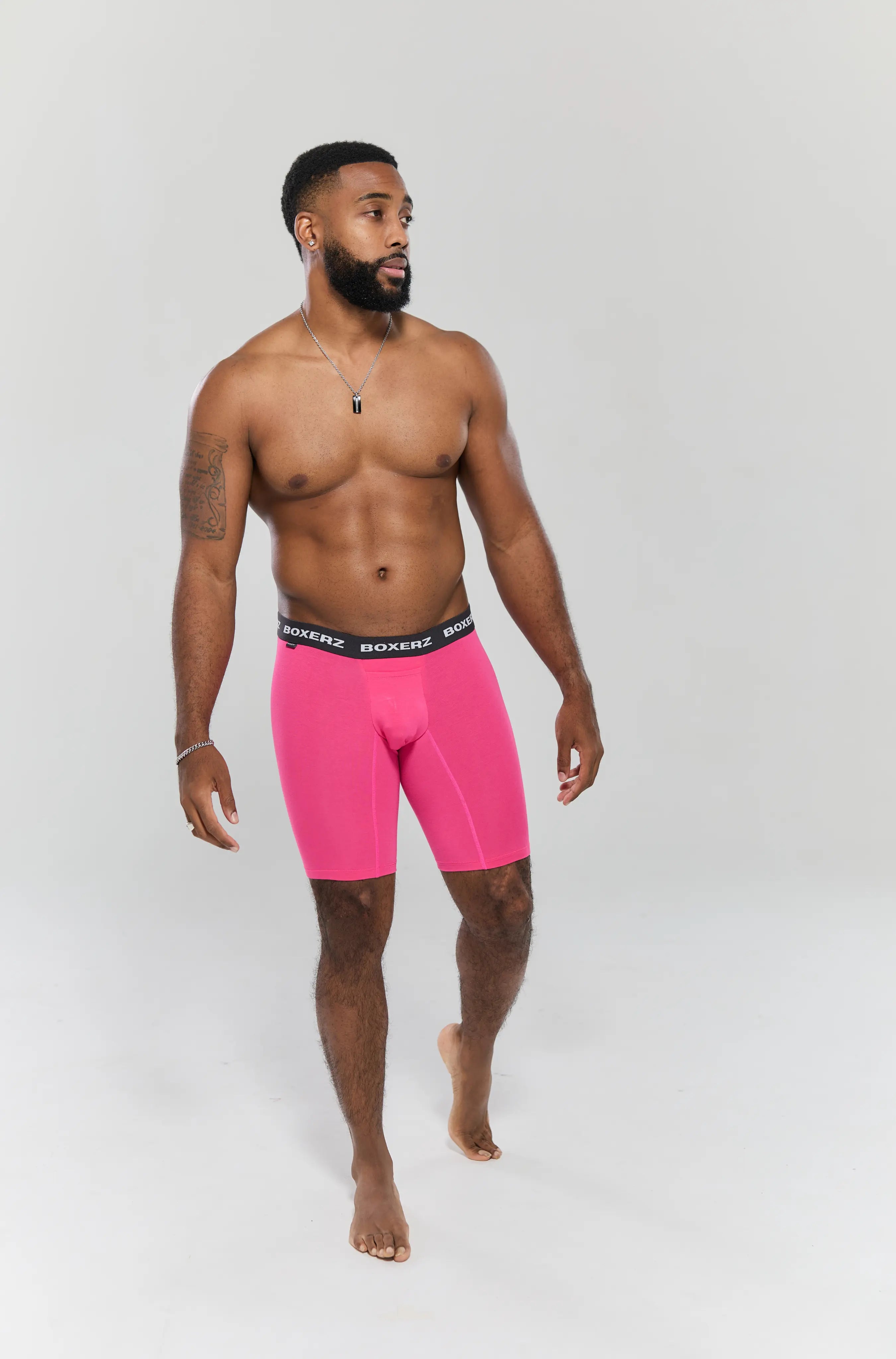 Full body front view of male model wearing pink boxer briefs from Boxerz, showing tailored fit and logo waistband

